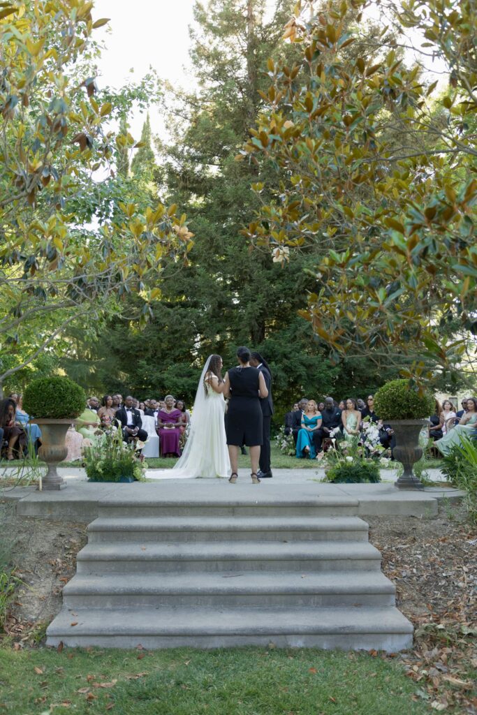 Wedding ceremony under magnolia tree at Park Winters, Park Winters wedding photographer Rose Freedman