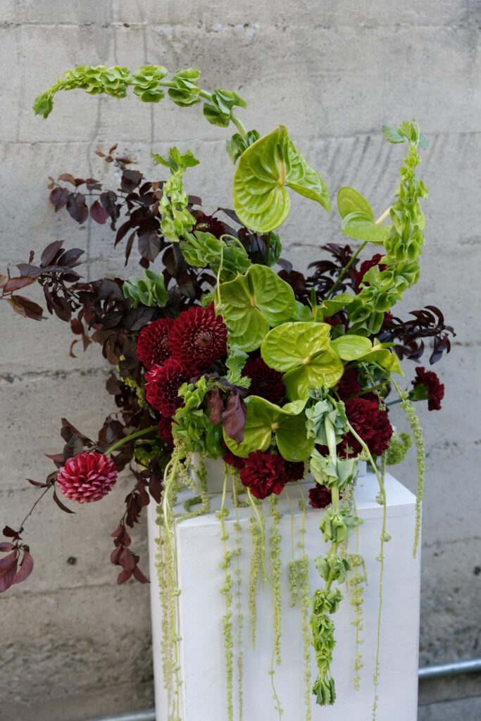 Dramatic burgundy and green anthurium floral installation at Palace of Fine Arts wedding, San Francisco wedding photographer Rose Freedman