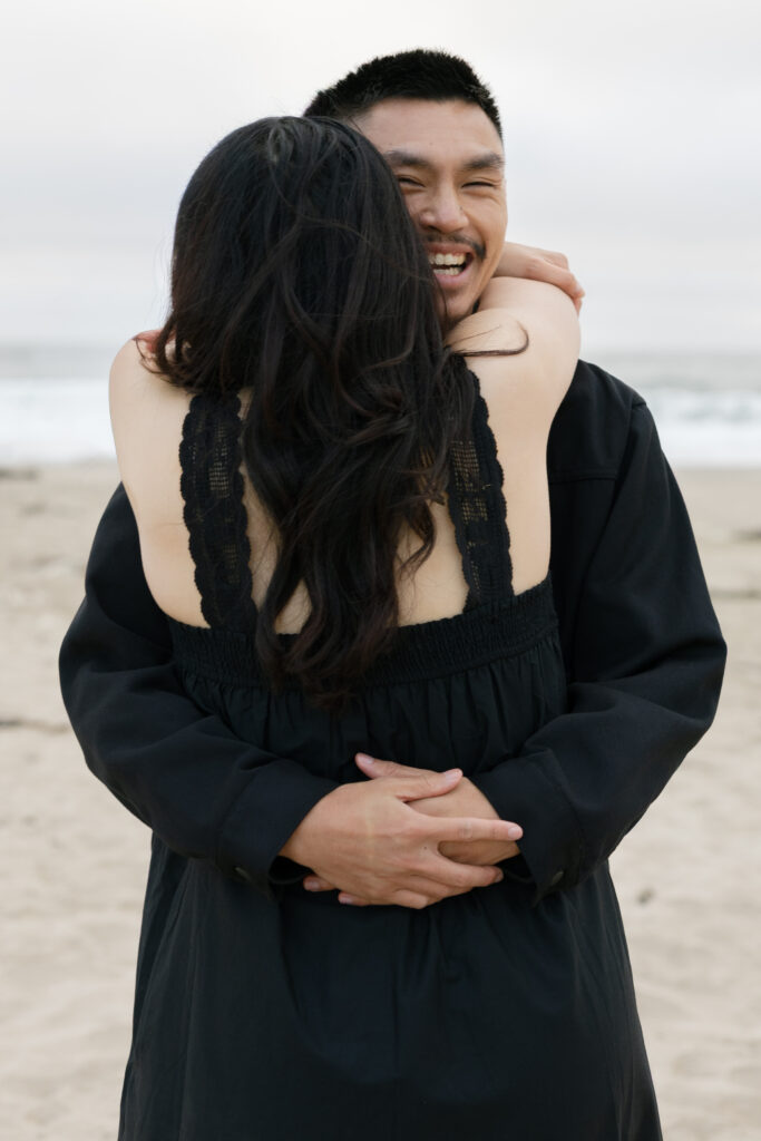 Couple embracing on Half Moon Bay beach, Bay Area couples photographer Rose Freedman