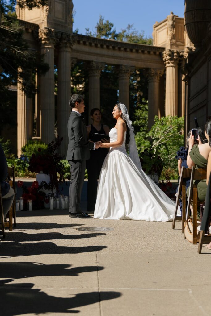 Bride and groom at altar during Palace of Fine Arts wedding ceremony San Francisco, Rose Freedman Photography