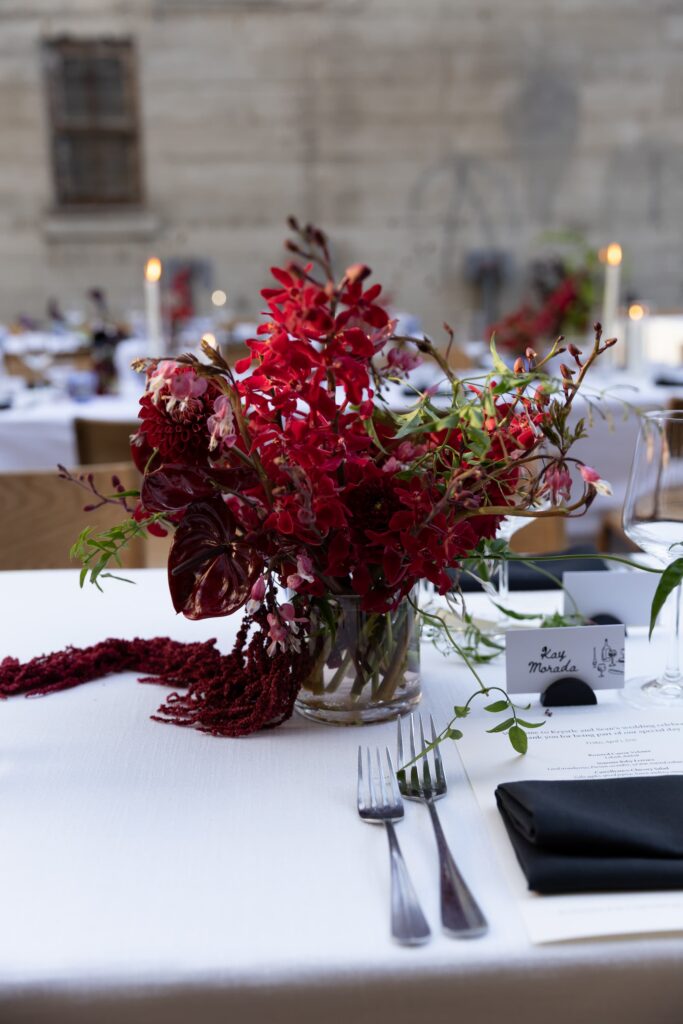 Burgundy orchid and dahlia centerpiece with place card at Foreign Cinema wedding reception, Rose Freedman Photography