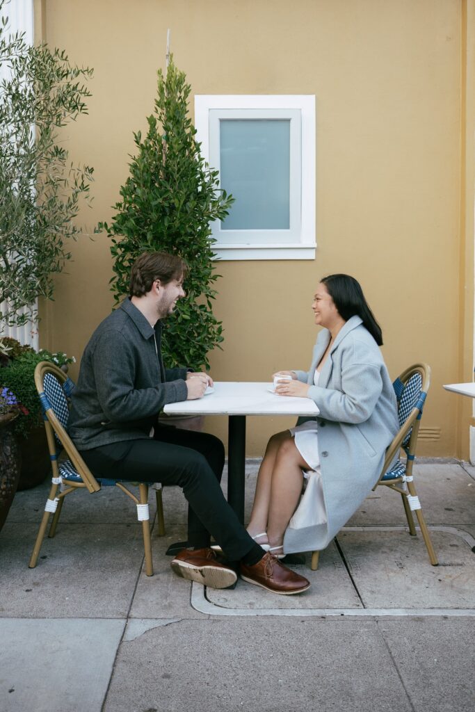 Couple at outdoor cafe table during San Francisco engagement session, Rose Freedman Photography