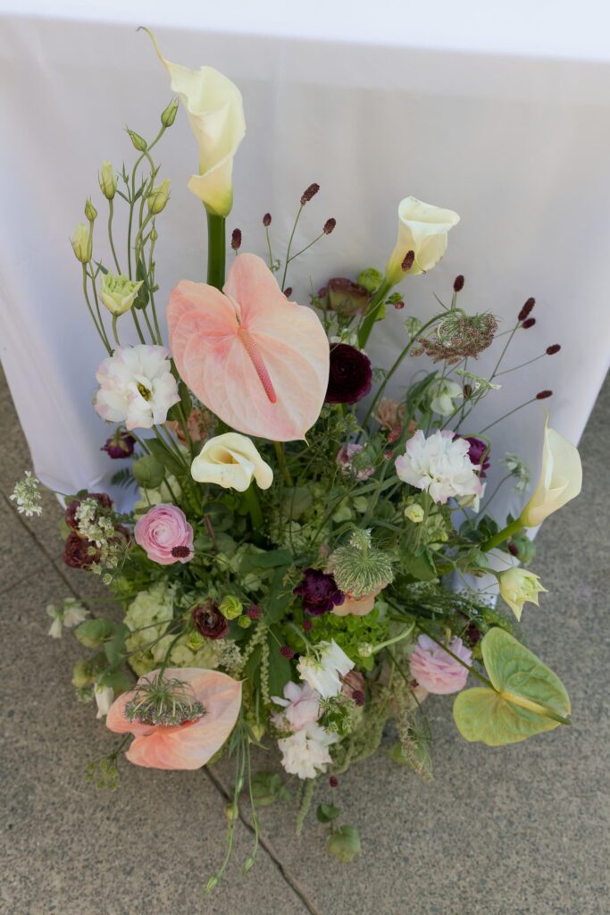 Lush garden floral centerpiece with anthurium, calla lilies, and ranunculus at Park Winters wedding, Rose Freedman Photography