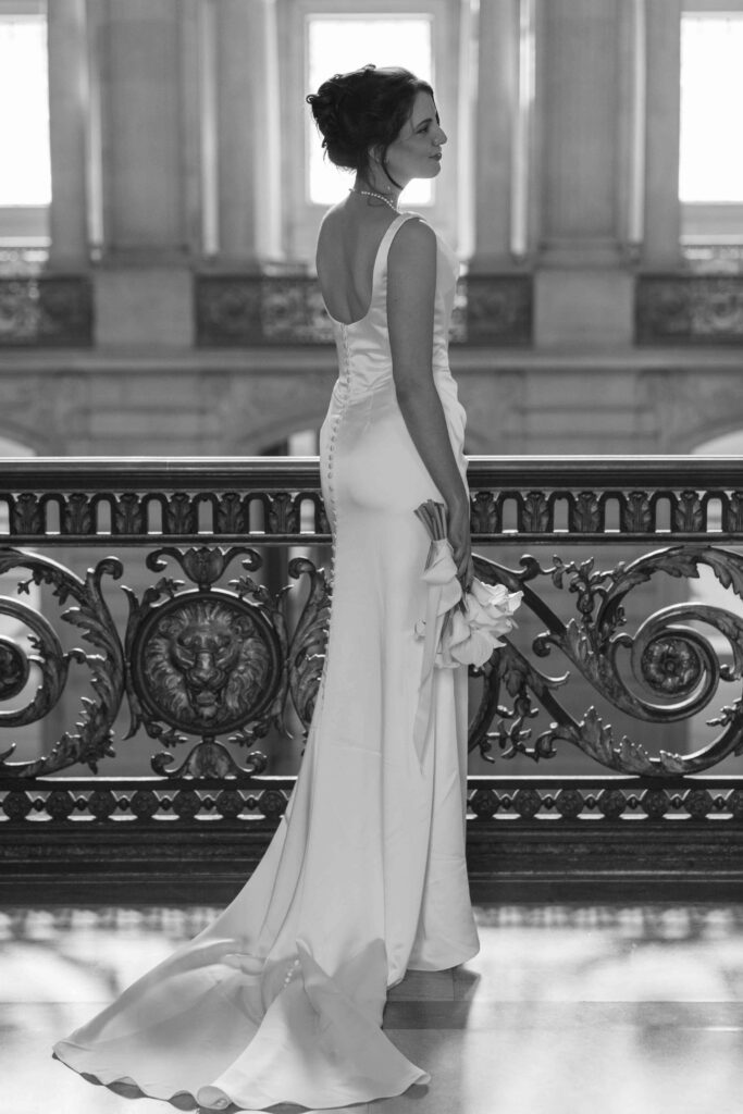 Bride in low-back gown with bow detail at SF City Hall, San Francisco wedding photographer Rose Freedman
