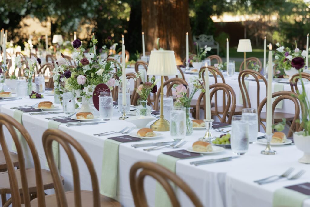 Outdoor reception table with gold candlestick lamp, sage linen runner, and floral centerpiece at Park Winters wedding, Park Winters wedding photographer Rose Freedman