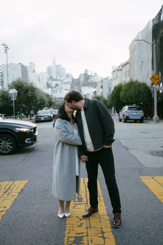Couple kissing on San Francisco street crosswalk, Bay Area engagement photographer Rose Freedman