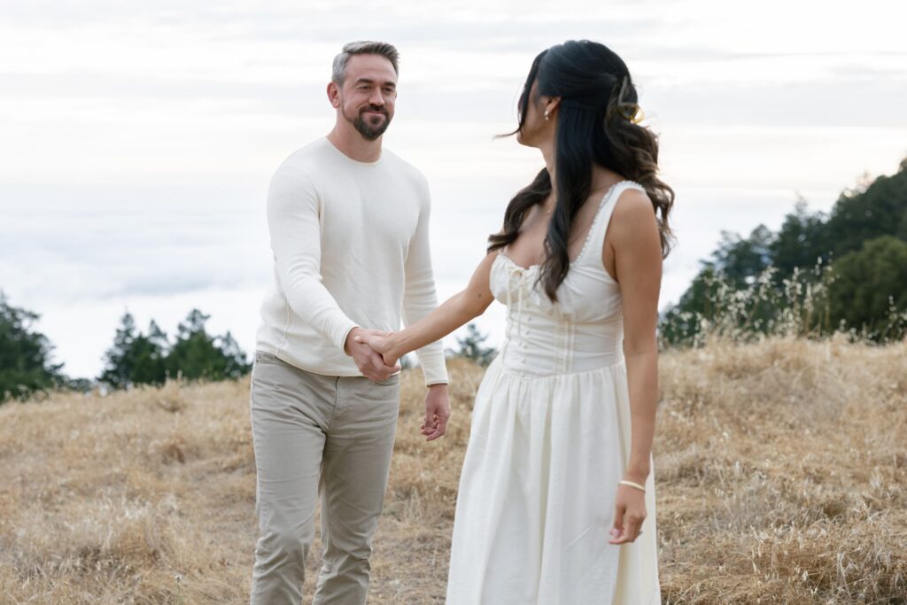 Couple holding hands walking on Mount Tamalpais golden hills, Bay Area engagement photographer Rose Freedman