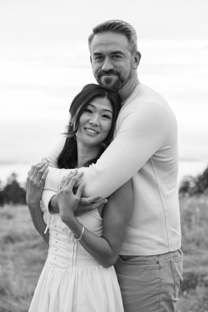 Black and white couple embracing and smiling at Mount Tamalpais engagement session, Bay Area engagement photographer Rose Freedman