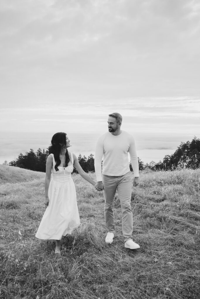 Black and white couple walking hand in hand on Mount Tamalpais golden hills, Bay Area engagement photographer Rose Freedman