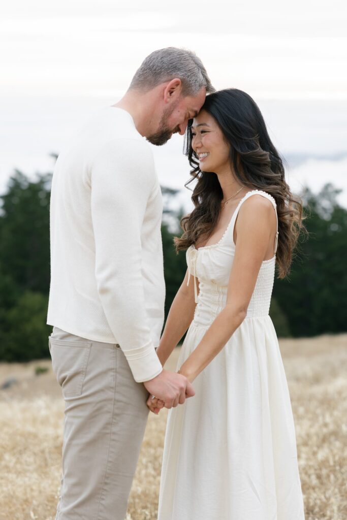 Couple touching foreheads and laughing at Mount Tamalpais engagement session, Bay Area engagement photographer Rose Freedman