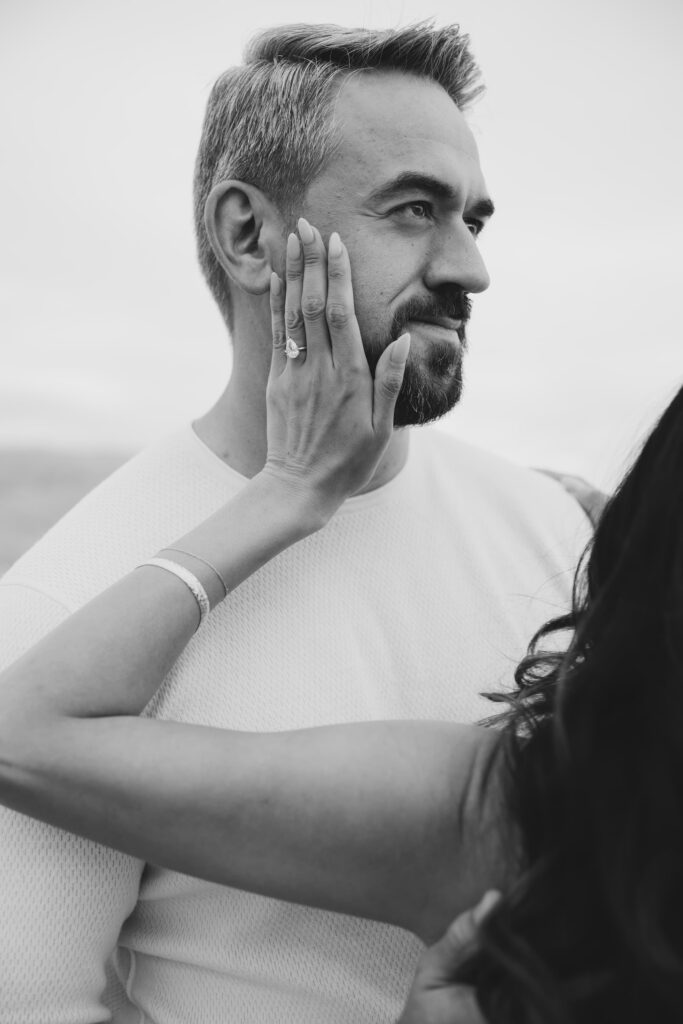 Black and white groom portrait with bride's hand and ring at Mount Tamalpais, Bay Area engagement photographer Rose Freedman