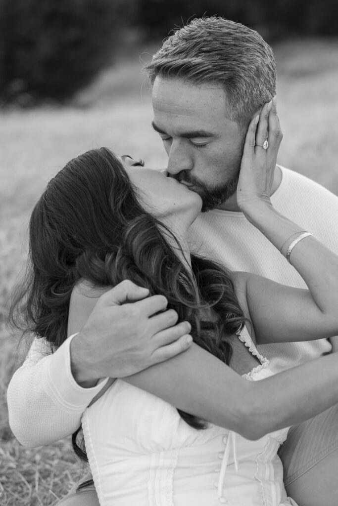 Black and white couple kissing with engagement ring at Mount Tamalpais, Bay Area engagement photographer Rose Freedman