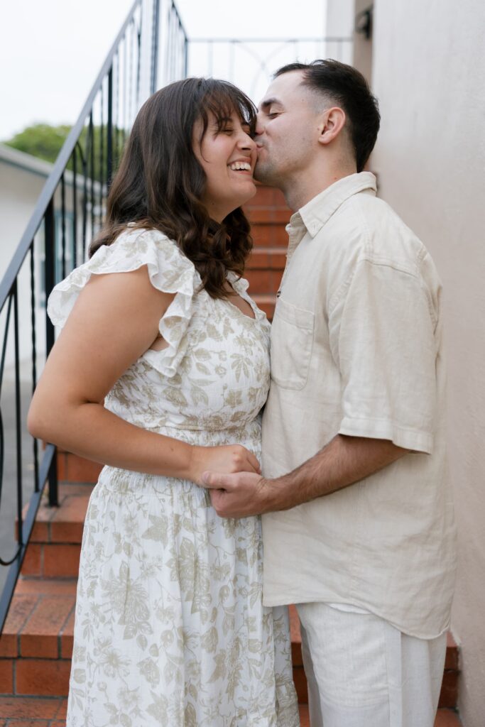 Couple kissing on staircase downtown Half Moon Bay, Bay Area anniversary photographer