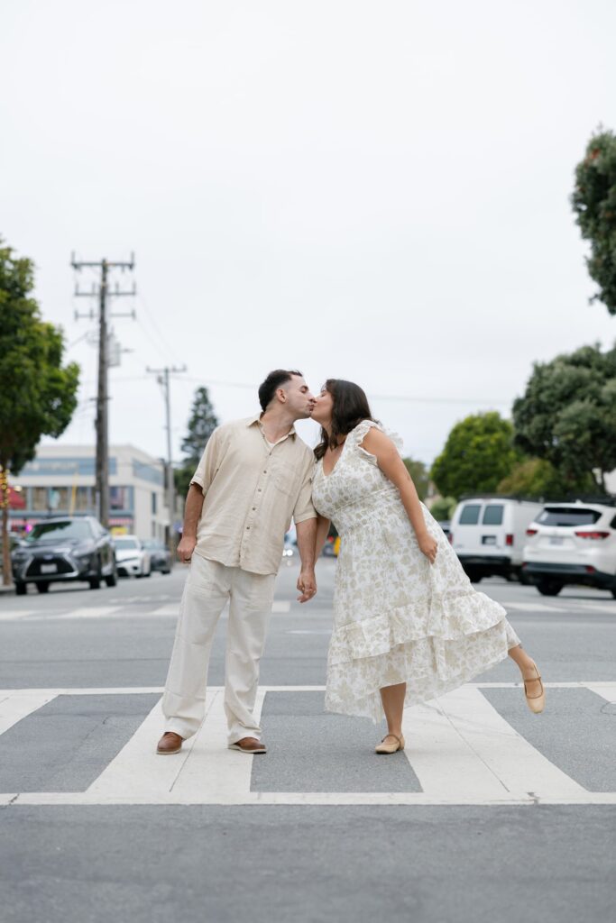 Couple kissing in crosswalk Half Moon Bay downtown, Bay Area anniversary photographer Rose Freedman