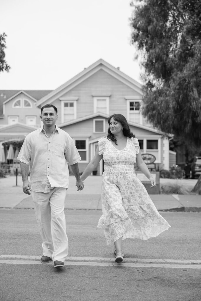 Couple walking hand in hand downtown Half Moon Bay, Bay Area couples photographer Rose Freedman