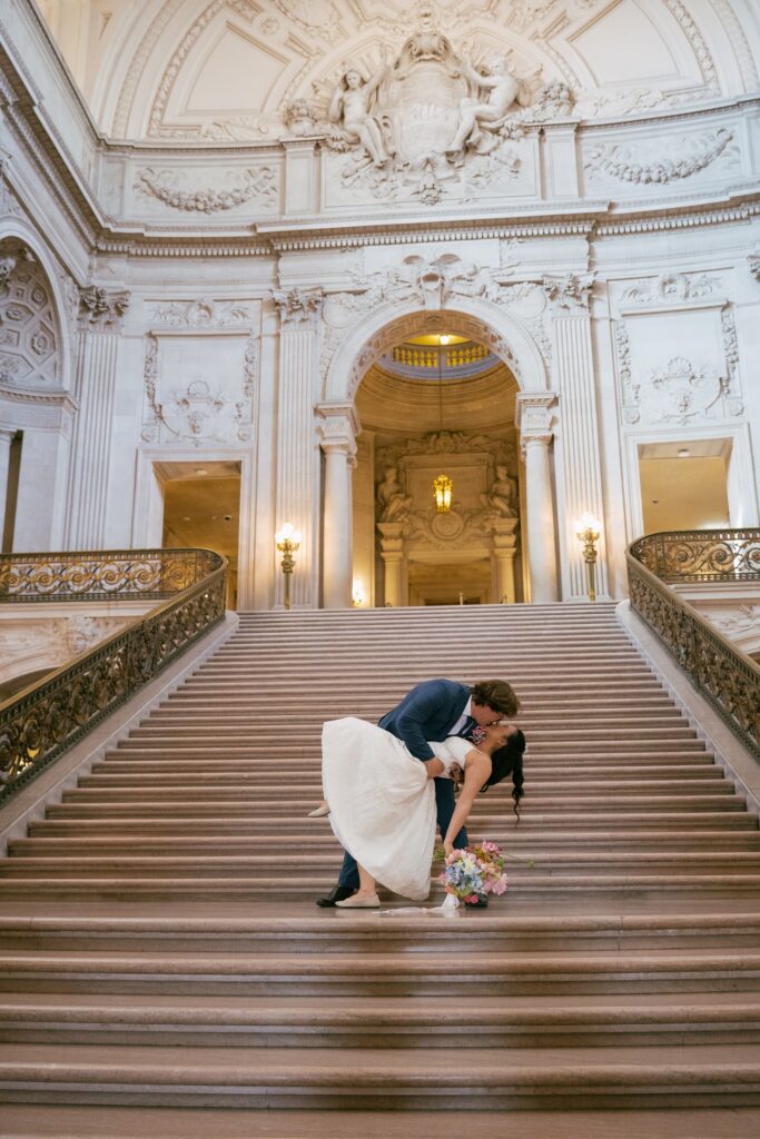 Couple on grand staircase San Francisco City Hall elopement, SF City Hall wedding photographer Rose Freedman