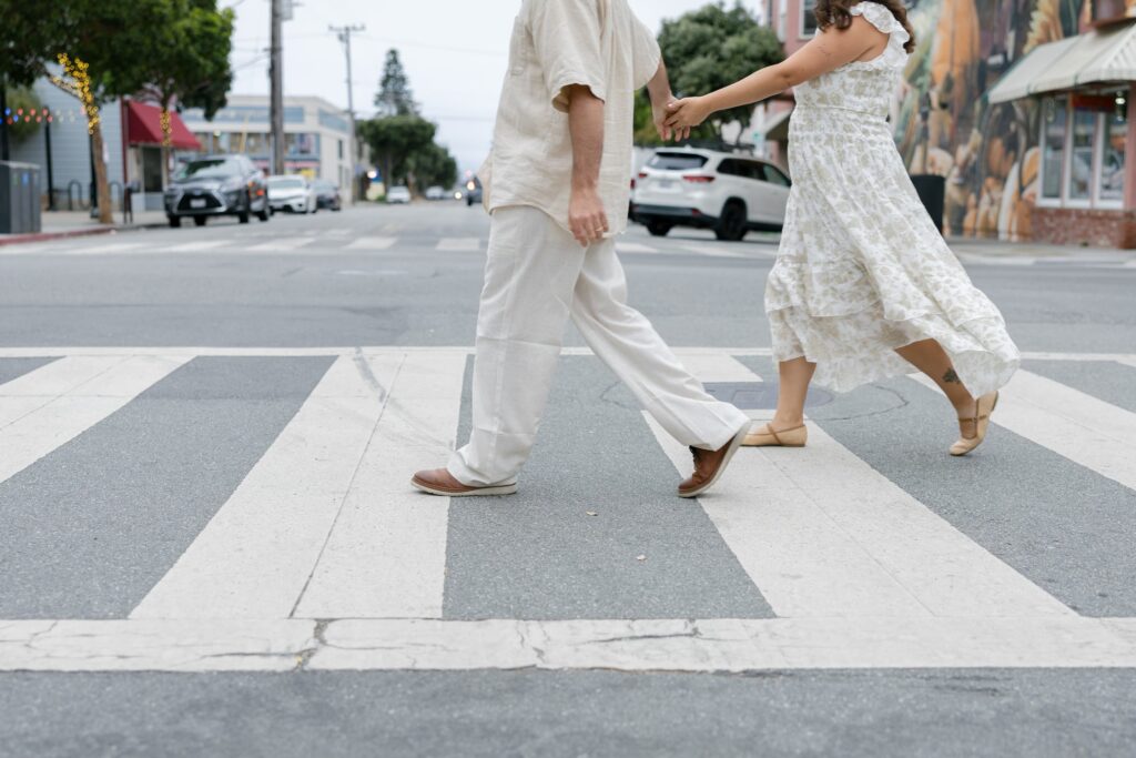 Couple walking through crosswalk detail shot, Half Moon Bay anniversary session Rose Freedman
