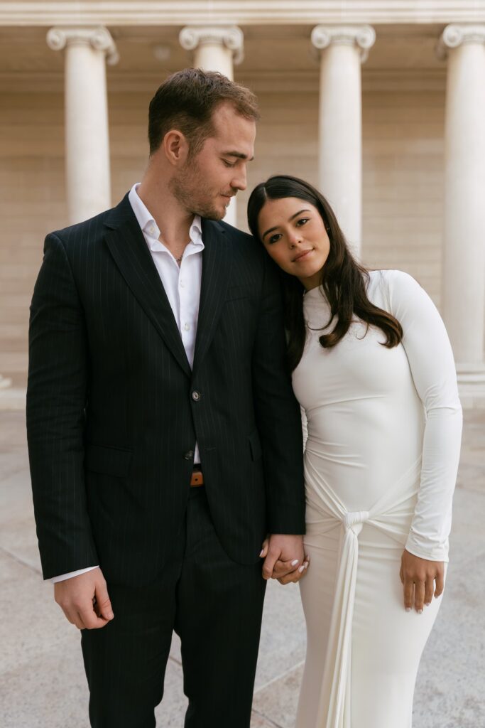 Elegant engagement portrait at Bay Area landmark, white dress and dark suit, Rose Freedman Photography