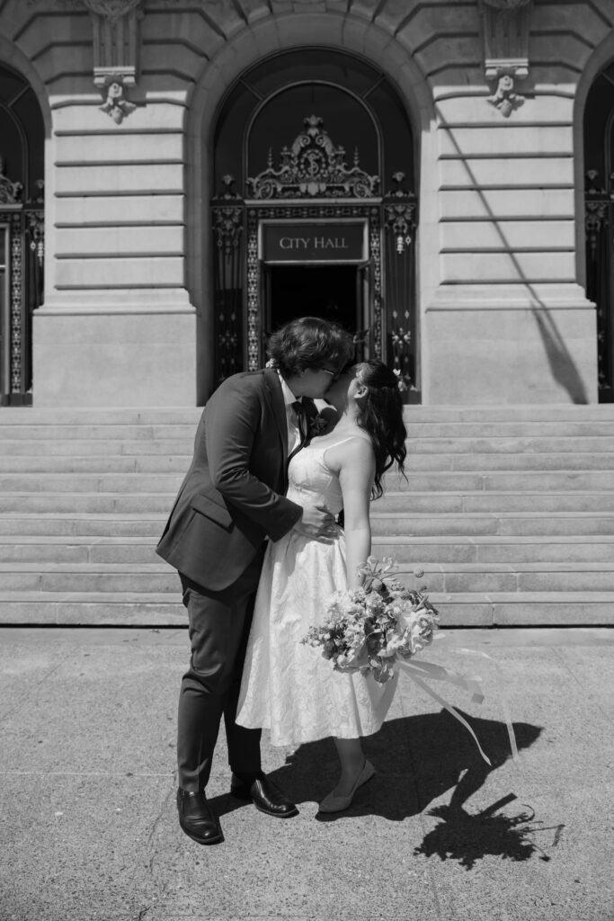 Couple kissing on San Francisco City Hall steps, City Hall elopement photographer Rose Freedman