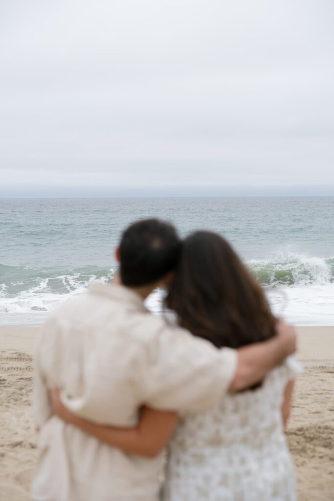 Couple facing ocean Half Moon Bay beach anniversary session, Bay Area photographer Rose Freedman