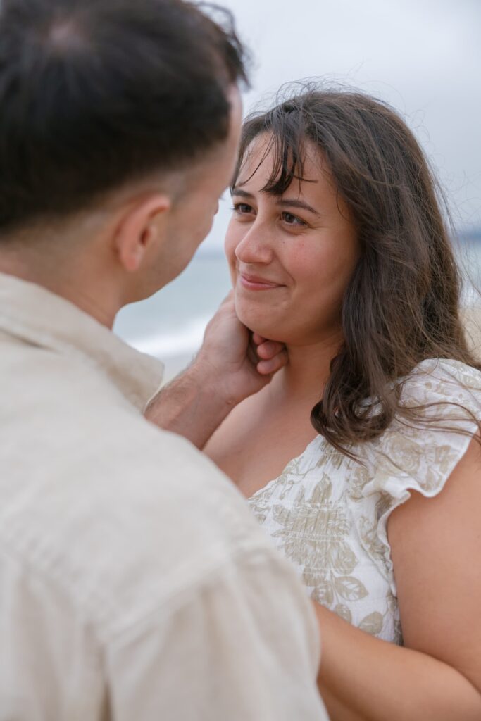 Couple embracing on Half Moon Bay beach, Northern California anniversary photographer