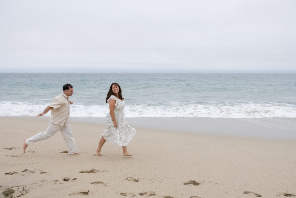 Couple running on Half Moon Bay beach anniversary session, Bay Area photographer Rose Freedman
