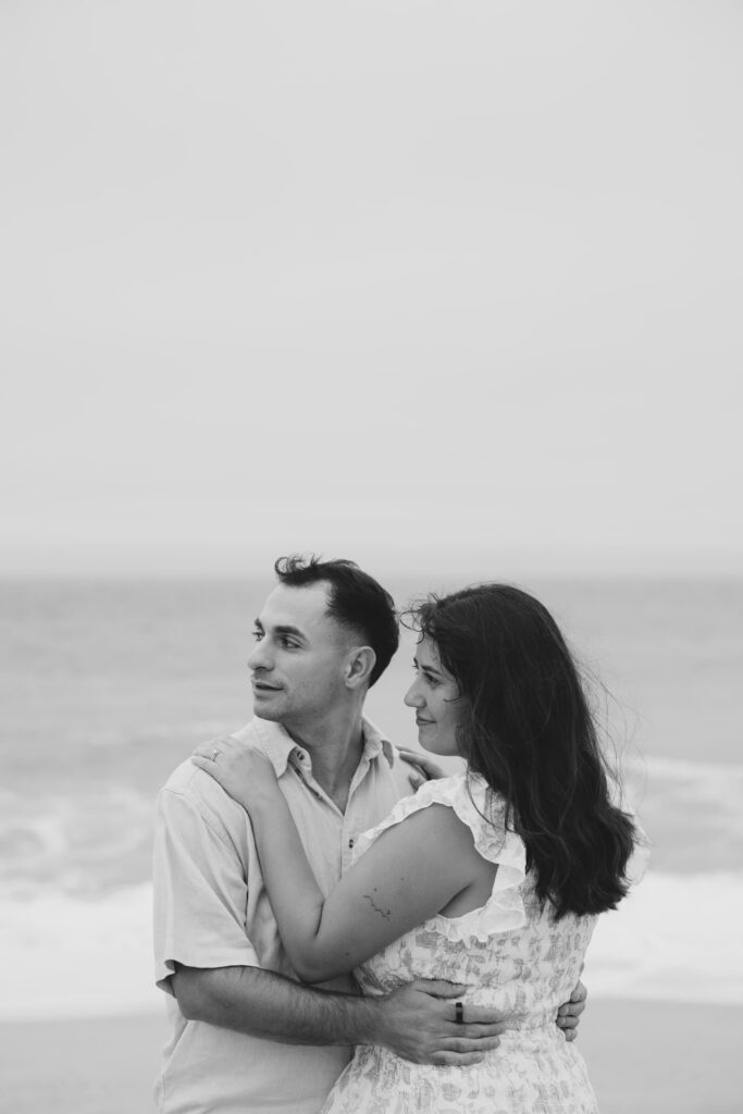 Couple embracing looking at ocean Half Moon Bay, Bay Area anniversary photographer