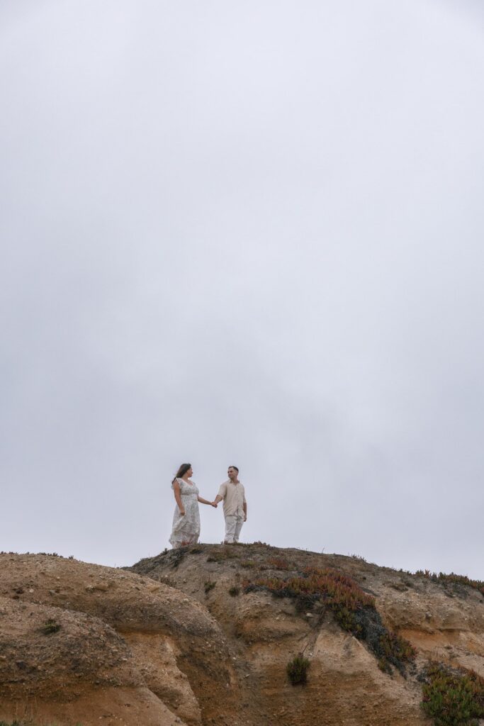 Couple standing on coastal cliffs Half Moon Bay, Bay Area anniversary photographer Rose Freedman
