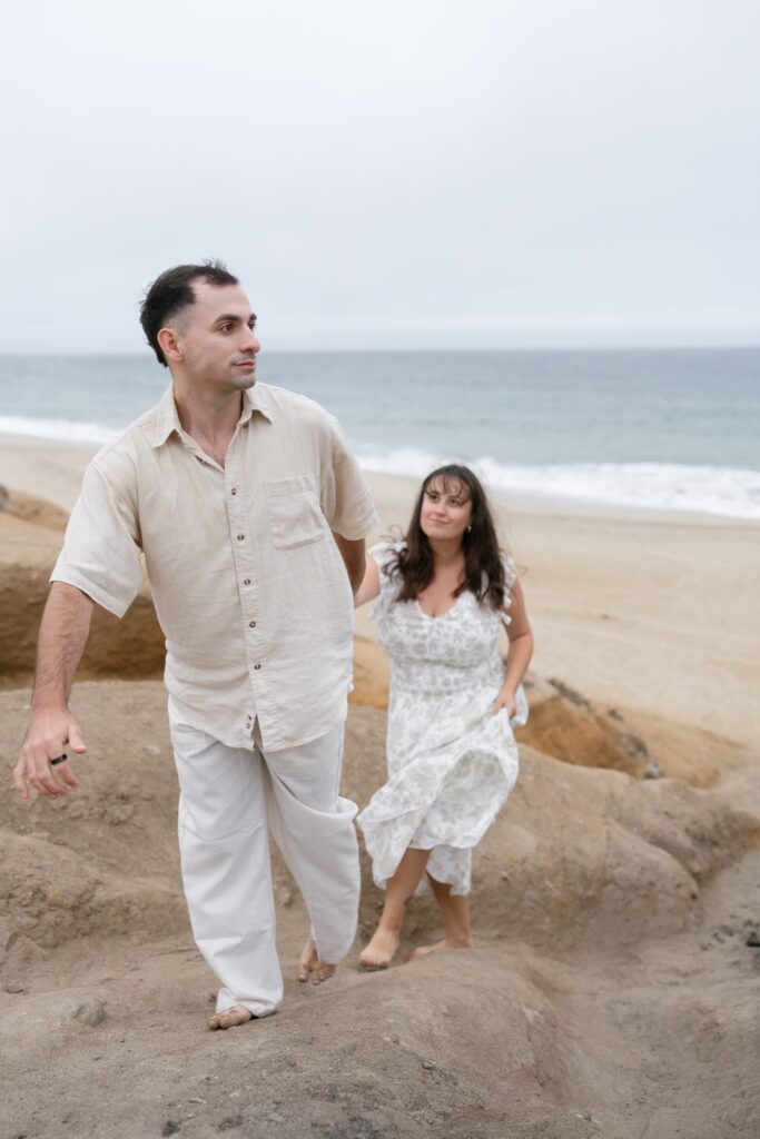 Couple walking up sand dunes Half Moon Bay beach, Rose Freedman Photography