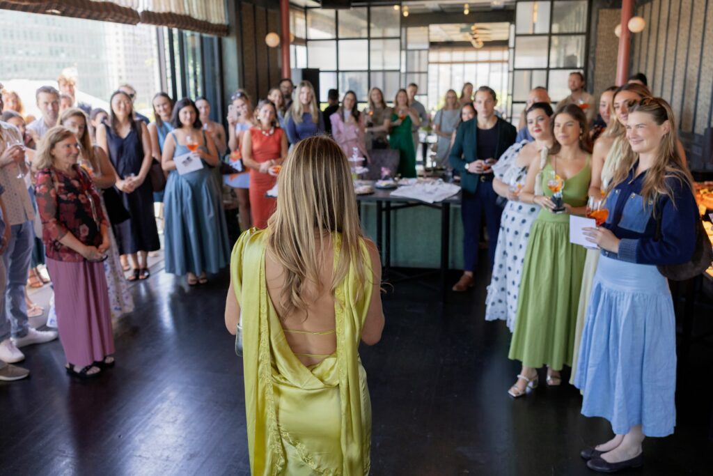 Wedding planner Liv of Adored Creations addressing guests at launch party Charmaine's Rooftop San Francisco, San Francisco event photographer Rose Freedman