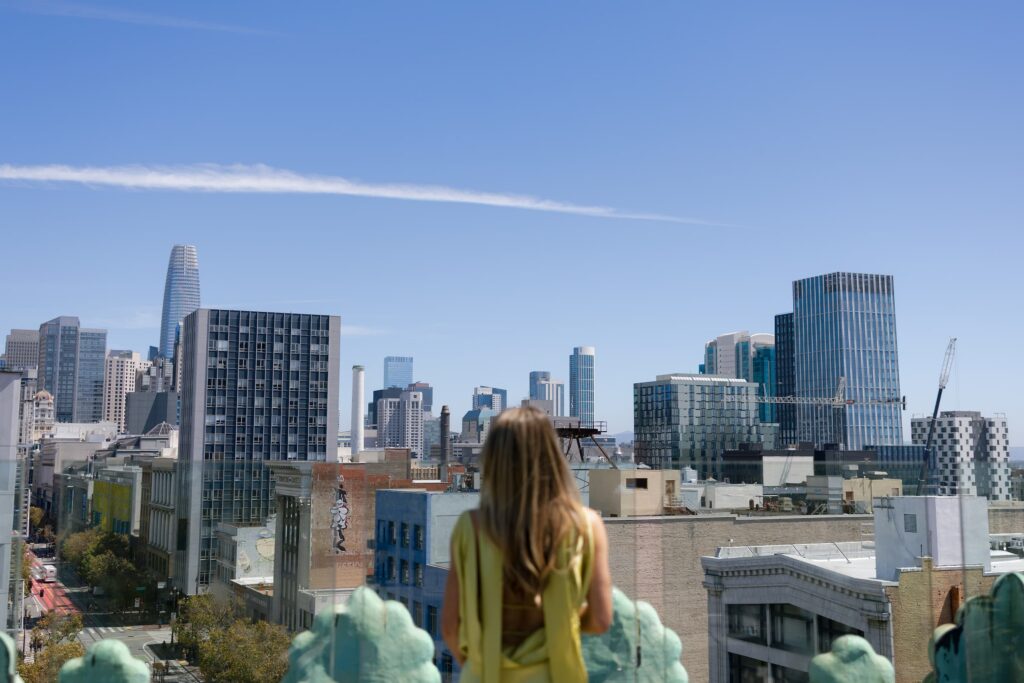 Wedding planner Liv of Adored Creations overlooking San Francisco skyline from Charmaine's Rooftop, San Francisco event photographer Rose Freedman