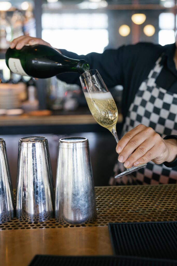 Champagne being poured at Charmaine's Rooftop bar San Francisco launch party, Rose Freedman Photography