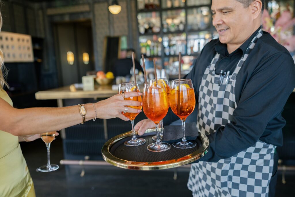 Aperol spritz cocktails being served at launch party Charmaine's Rooftop San Francisco, Rose Freedman Photography