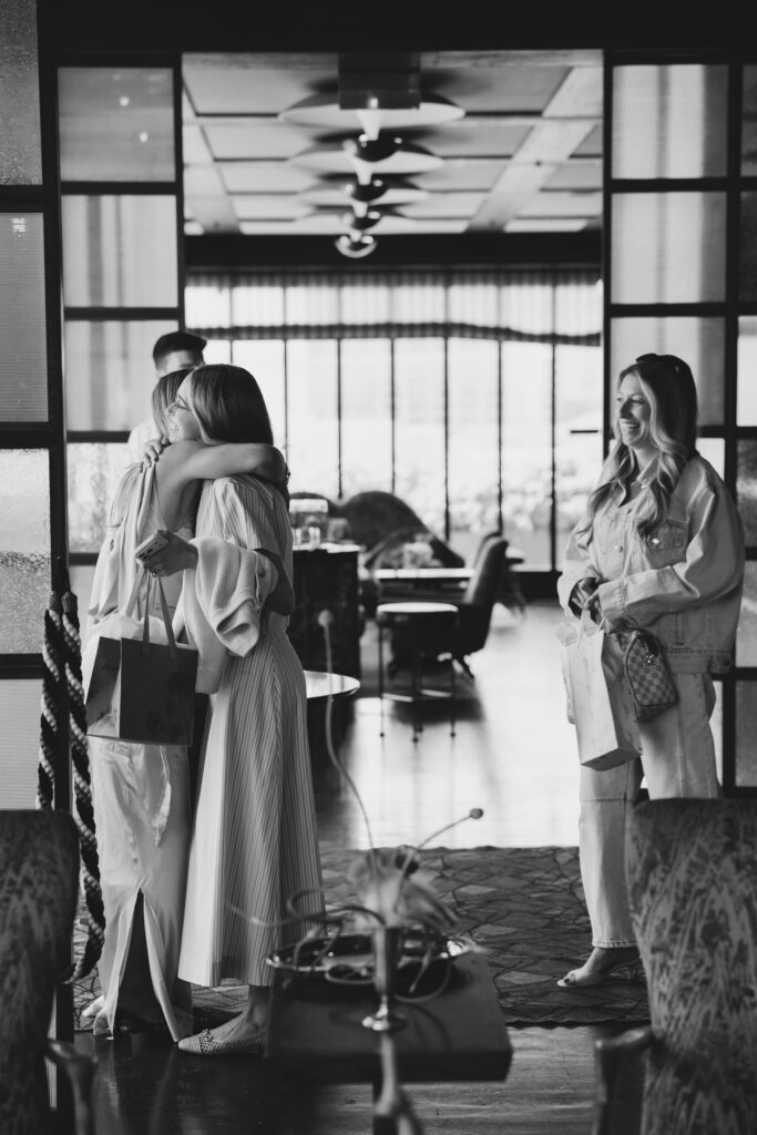 Guests embracing at Adored Creations launch party Charmaine's Rooftop San Francisco, Rose Freedman Photography