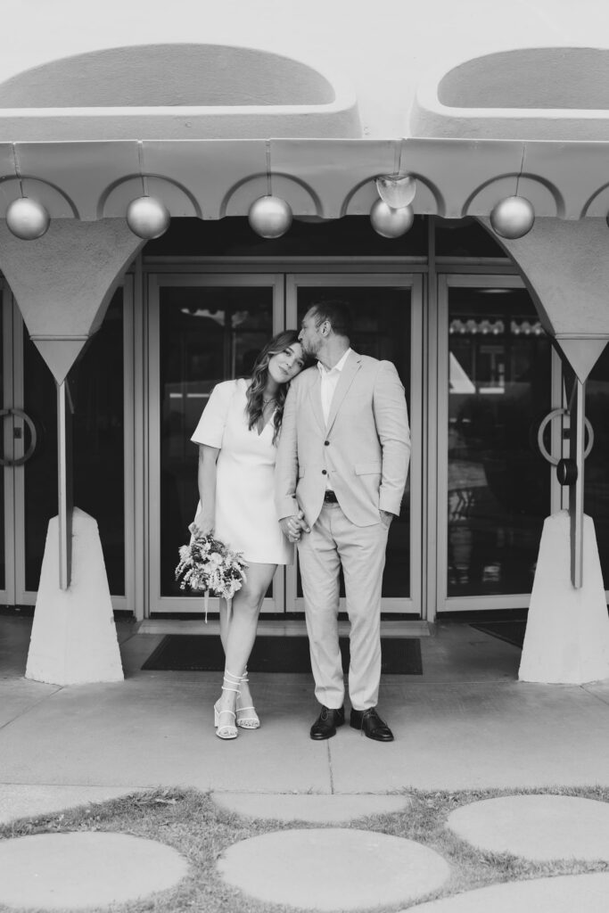 Couple kissing at entrance of Marin Civic Center elopement, Rose Freedman Photography