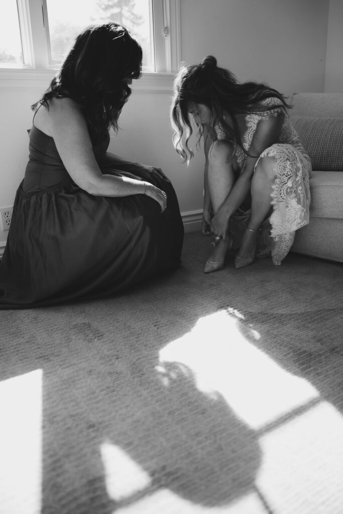 Mother helping bride put on heels getting ready Marin elopement, Rose Freedman Photography