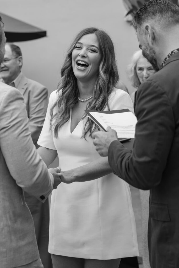 Bride laughing during elopement ceremony vows at Marin Civic Center, Rose Freedman Photography