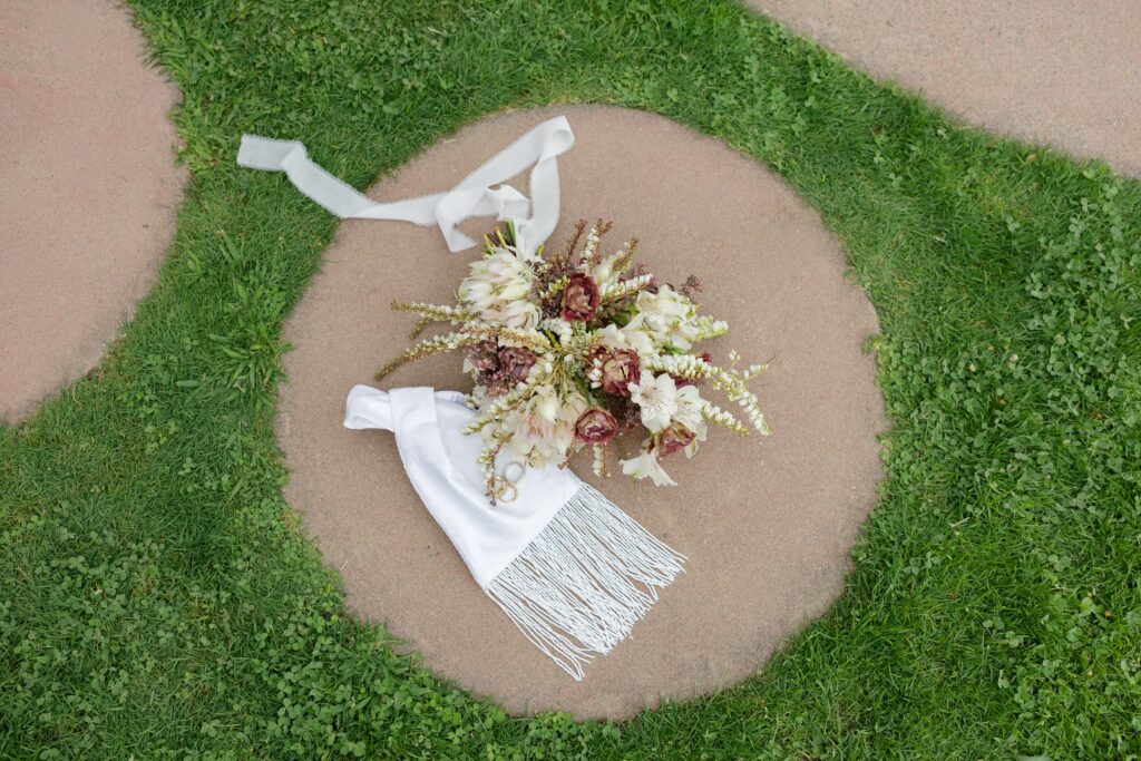 Bridal bouquet with burgundy and white flowers with fringe dress detail, Marin elopement Rose Freedman Photography
