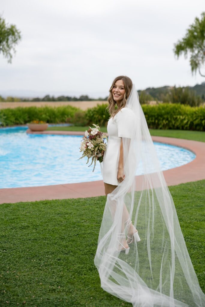 Bride in veil by pool at Marin Civic Center elopement, Rose Freedman Photography